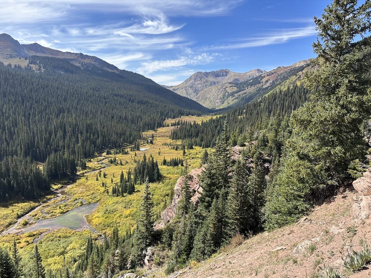 Mountain valley in the North Fork Zone of the Snowmass Wildersness with evergreen forest and winding river