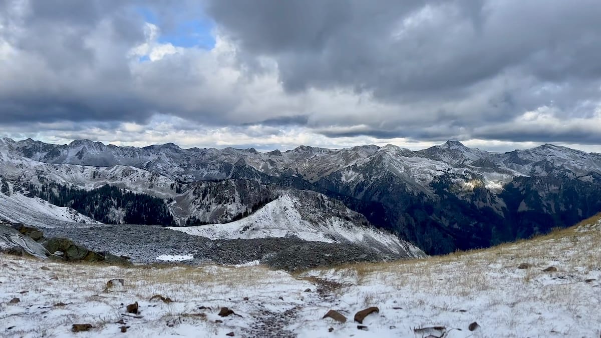 Snowy mountain range under overcast sky on Capitol Peak Trail.