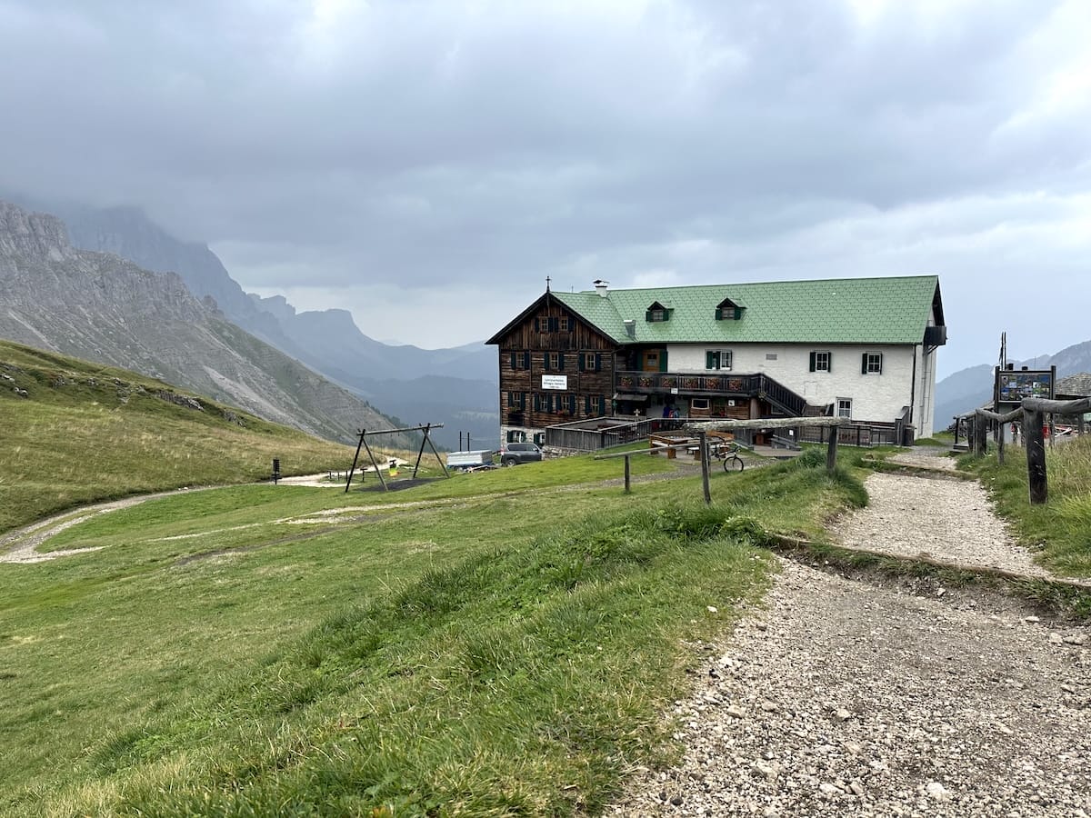 Rifugio Genova, a mountain hut along the Alta Via 2 trail, with mountain views.