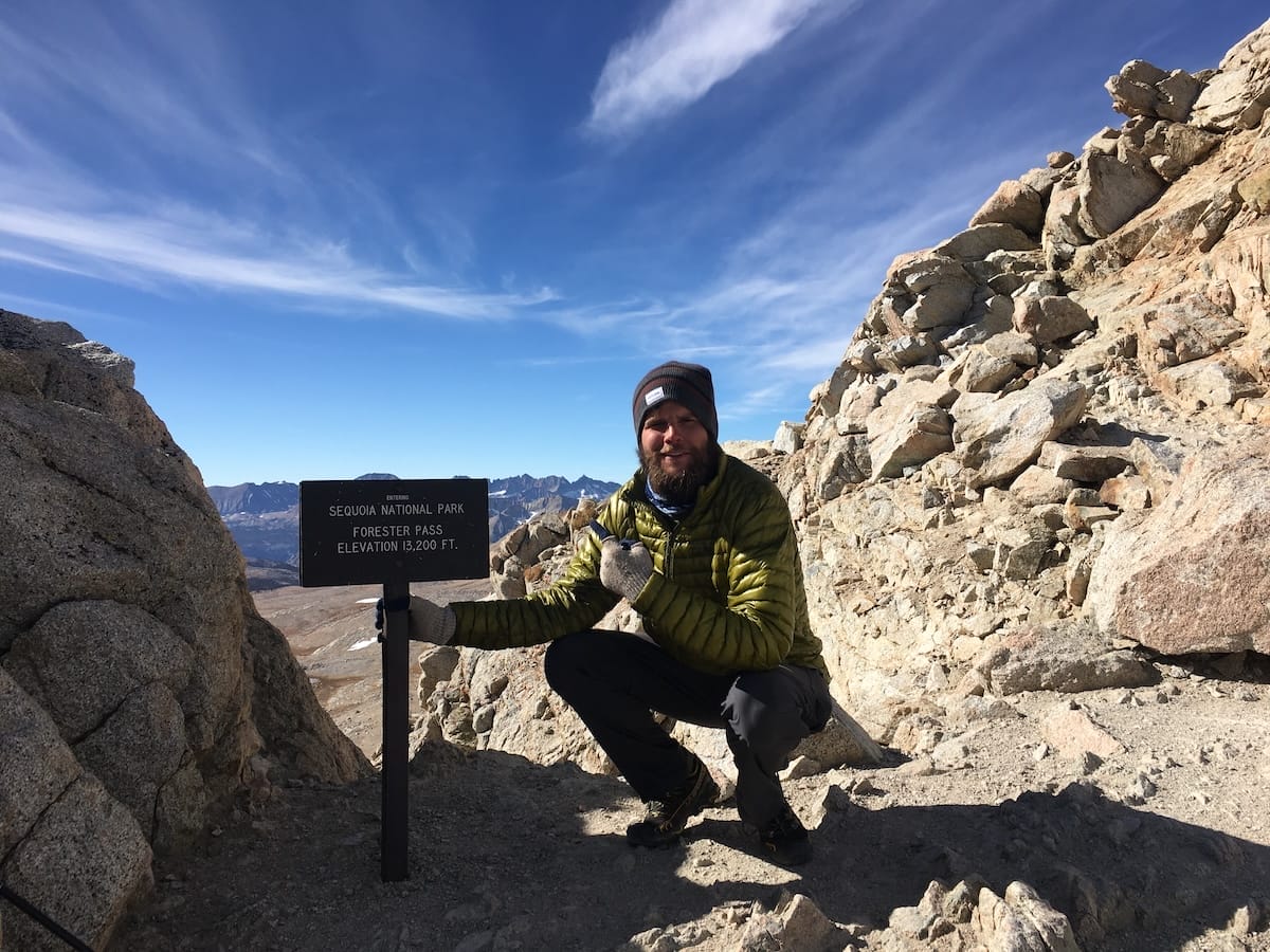 ghost-whisperer-forester-pass-pct PCT thru hiker on Forester Pass in cold weather gear including Mountain Hardwear Ghost Whisperer