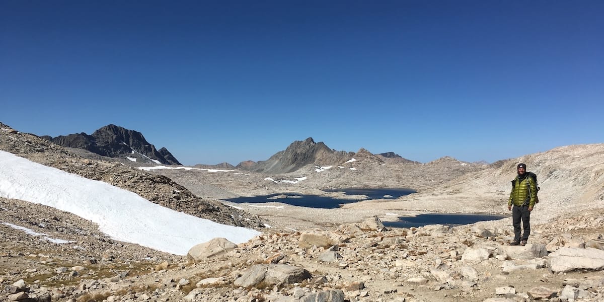 PCT thru hiker in the Sierra Nevada wearing a Mountain Hardware Ghost Whisperer down jacket.