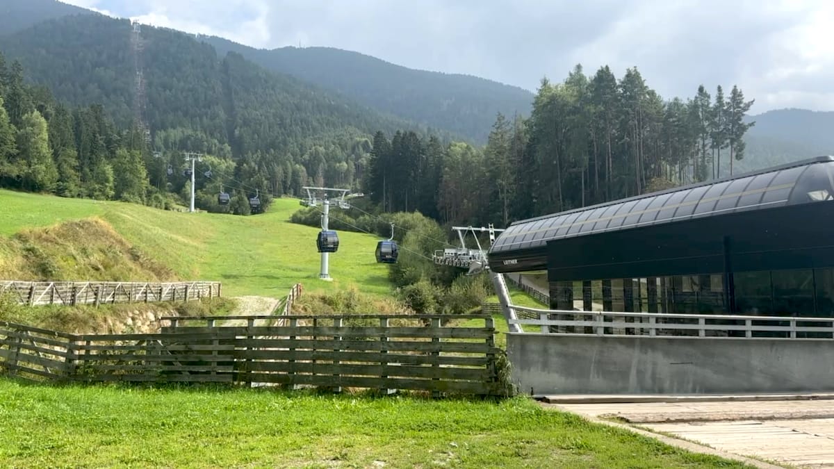 Plose Gondola station, access point for Alta Via 2, with gondola cabins ascending the mountain.