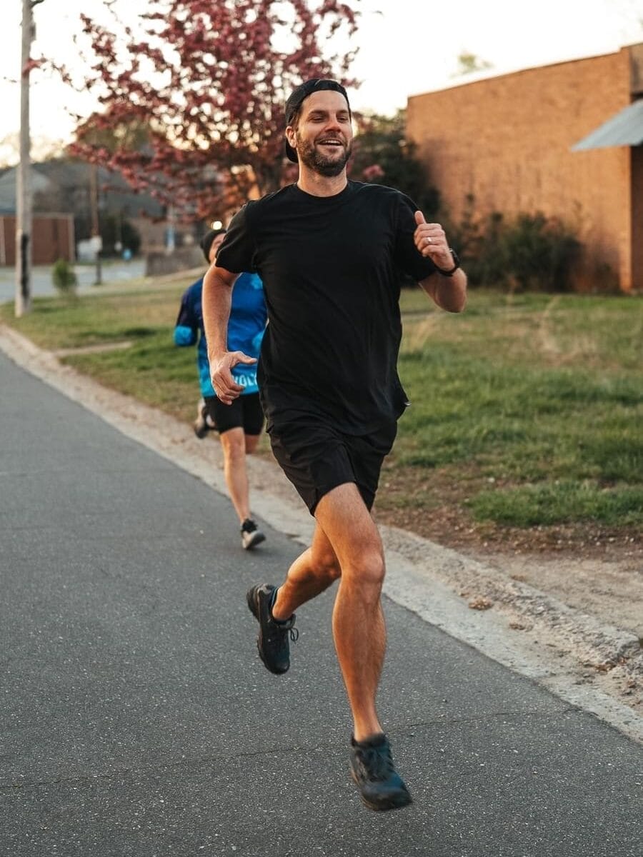 talljoe-running-paved-street Tall Joe running on a paved street near warehouses.